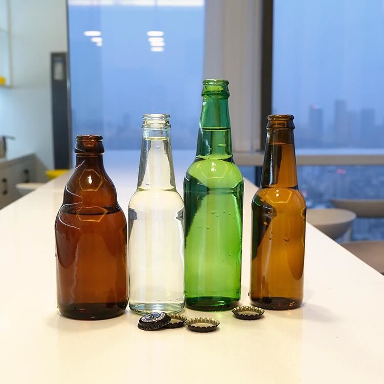 高品質の緑色アンバービール ガラスボトル 透明なホットスタンプビール飲料